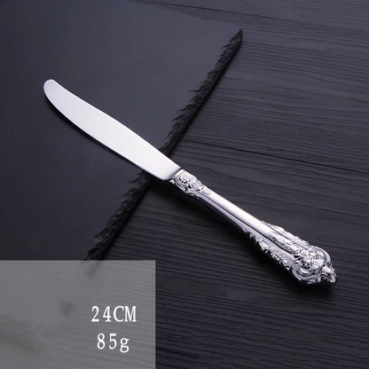 Four-piece stainless steel cutlery set showing main knife, fork, spoon, and teaspoon with mirror finish