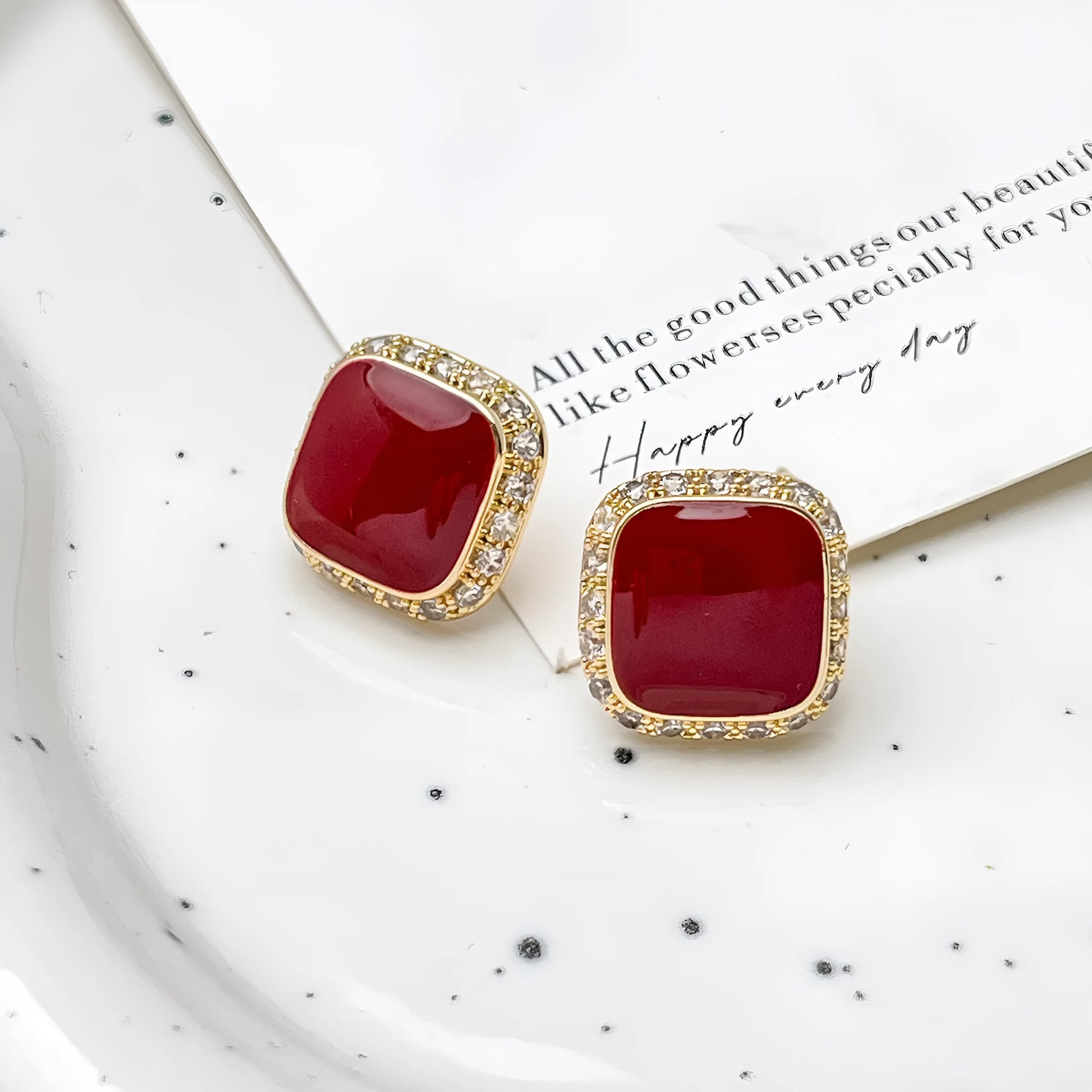 Red square alloy earrings with an inlaid geometric design, shown from the front.