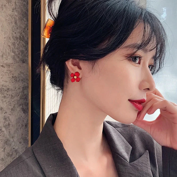 Silver-tone earrings with delicate red petal design, perfect for adding a touch of Korean-inspired elegance to any outfit.