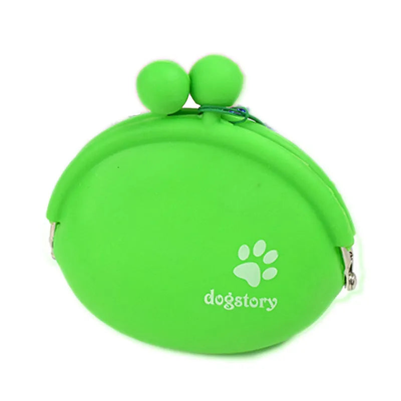 Yellow silicone dog training treat pouch with a black hook and loop waist strap, shown with dog biscuits.
