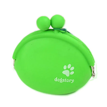 Yellow silicone dog training treat pouch with a black hook and loop waist strap, shown with dog biscuits.