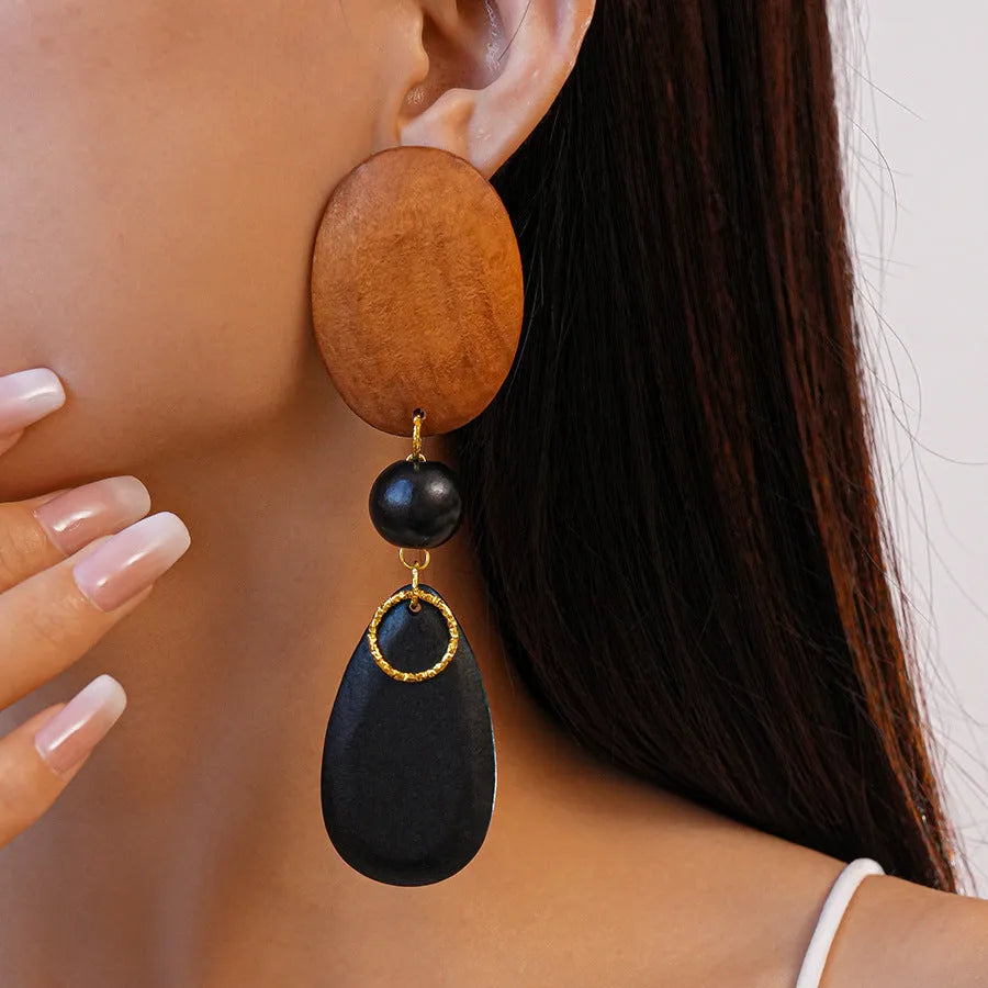 Wooden ellipse drop earrings with brown-black colour and silver needle accents