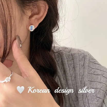 Women's S925 sterling silver earrings with oval blue diamond heart-wrapped design