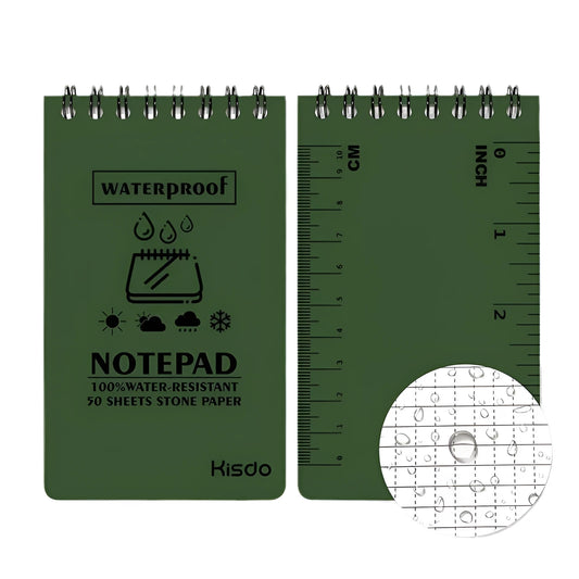 Spiral-bound waterproof notepad in camouflage colour, open on a desk with a pen, showing stone paper pages.