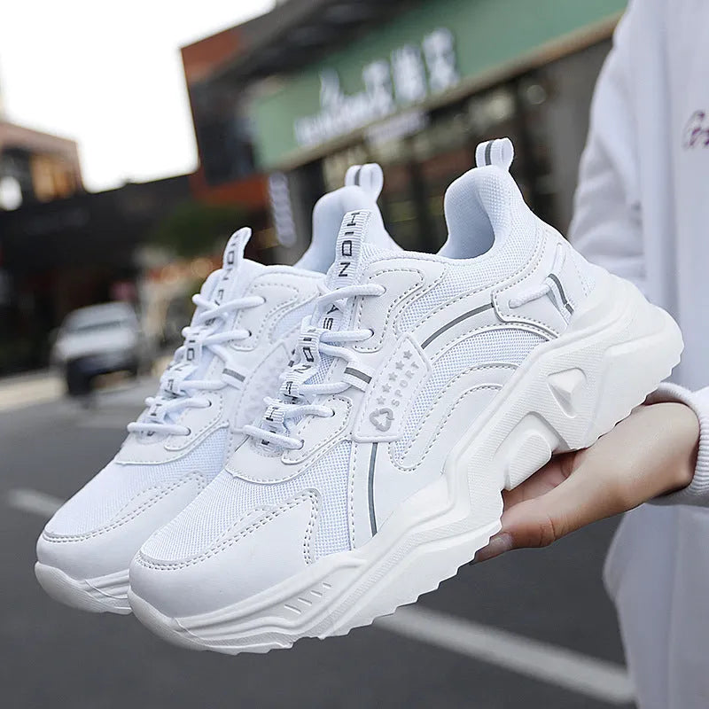 Women's white casual sports shoes with mesh upper, thick sole, buckle strap, and round toe.