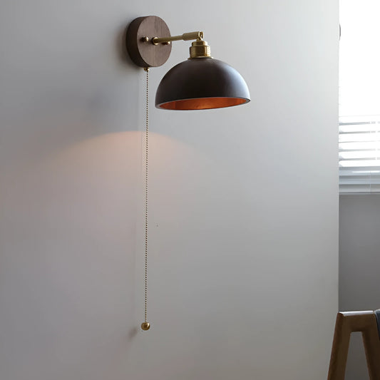 Inn Niche Nordic style wall lamp in walnut colour finish mounted beside a bed