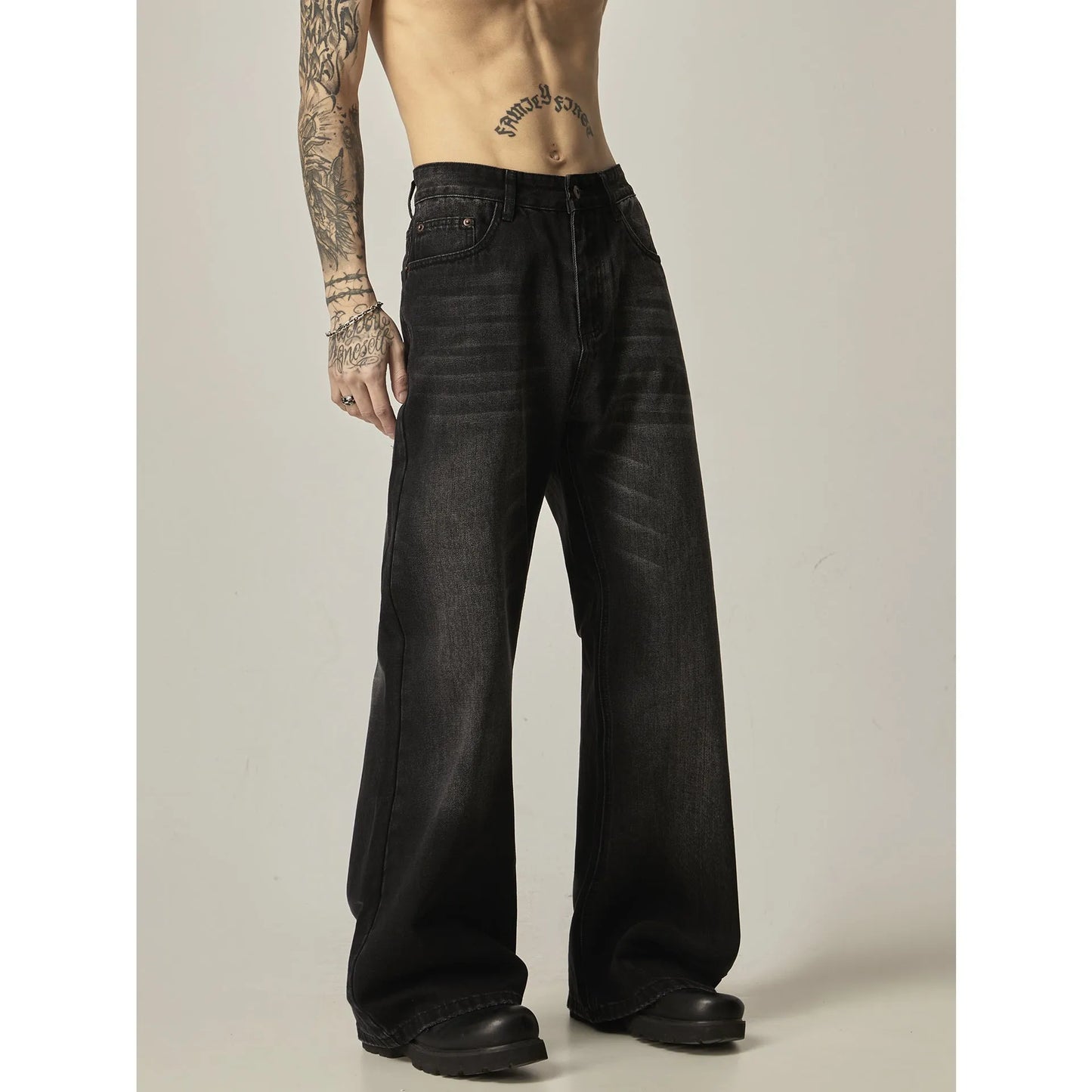 Black loose straight jeans with retro styling, zipper fly, and inelastic denim fabric