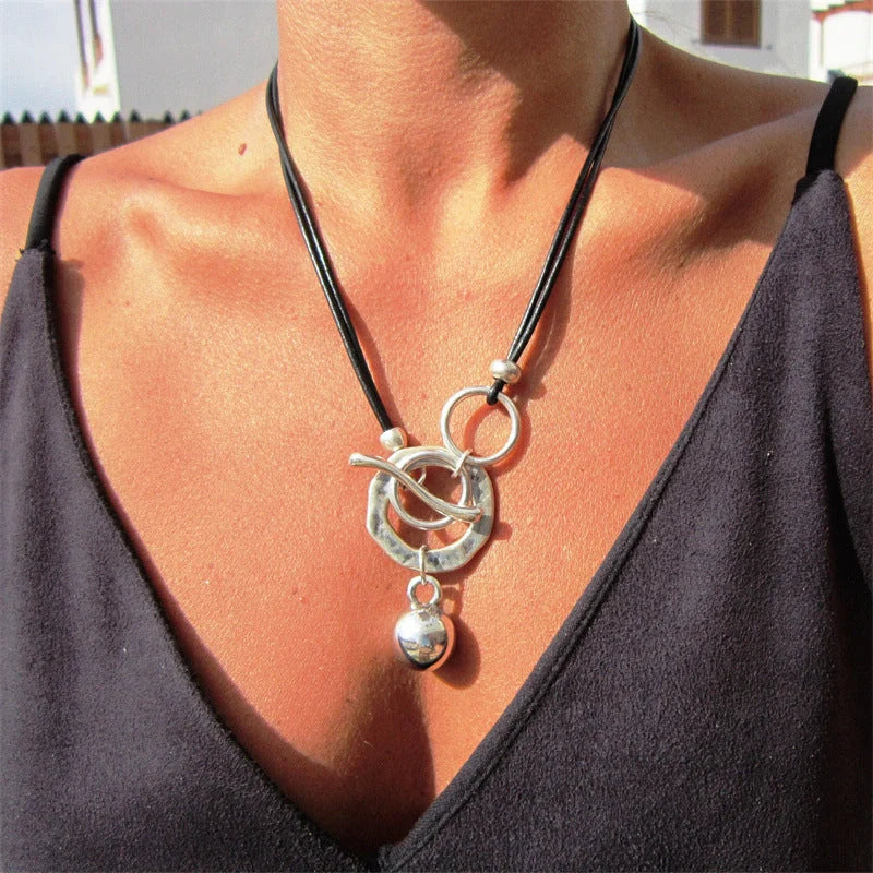 Stylish leather necklace with a boho-chic buckle detail, perfect for adding a touch of rustic charm to any outfit.