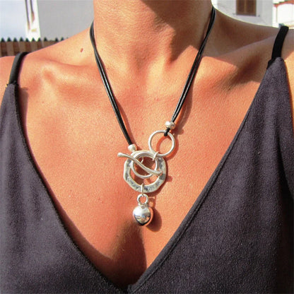 Stylish leather necklace with a boho-chic buckle detail, perfect for adding a touch of rustic charm to any outfit.