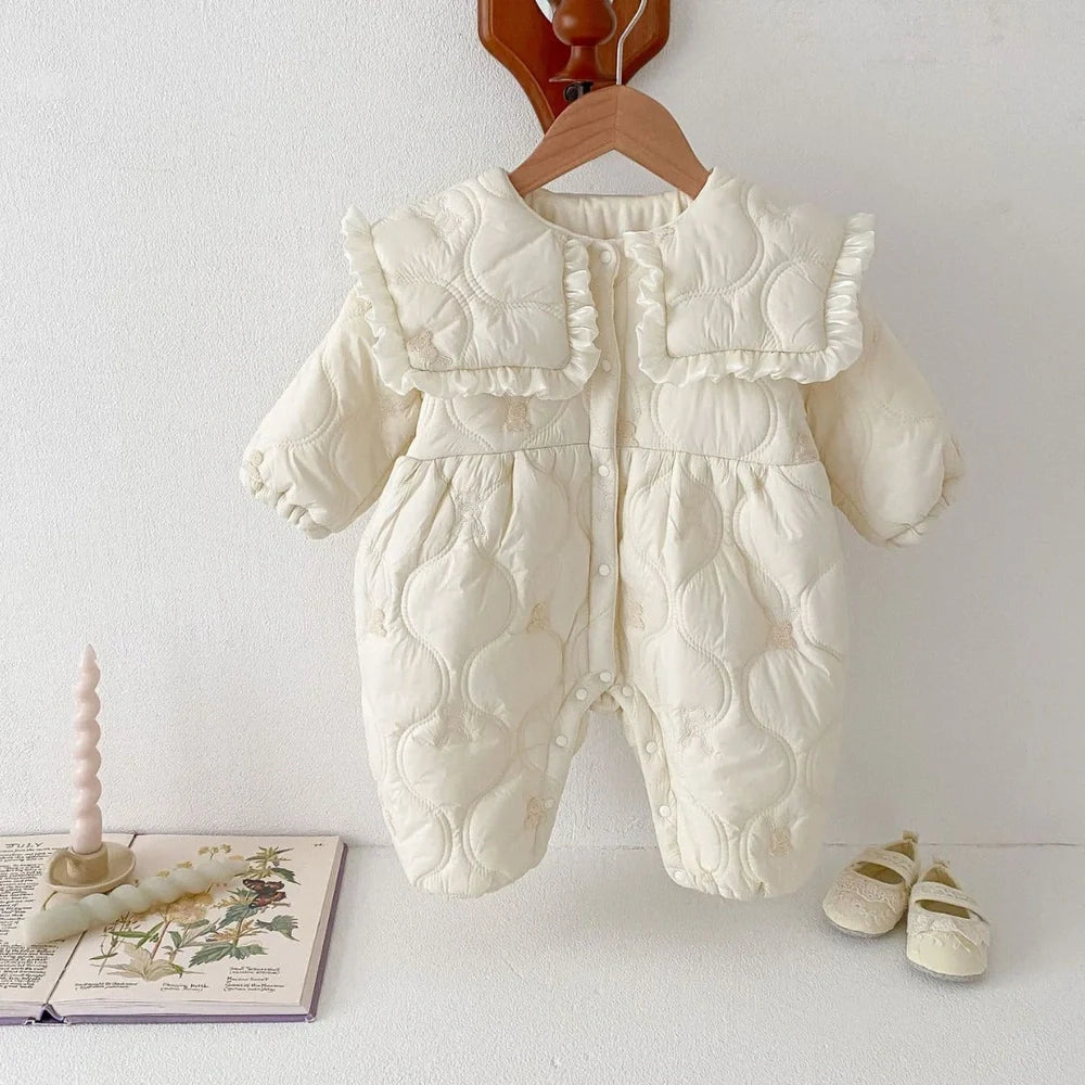 Newborn in light beige fleece-lined quilted cotton jumpsuit with single-breasted closure