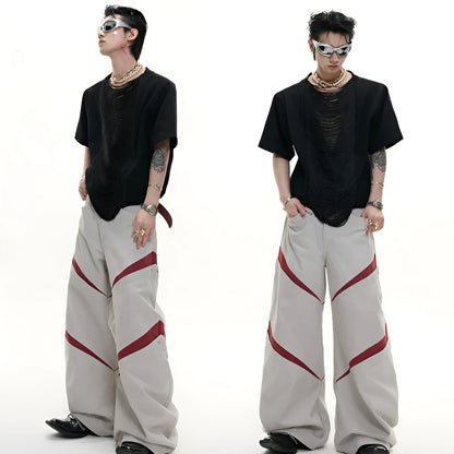 Men's loose fit black t-shirt with a hollow-out V-neck collar and tassel detail on short sleeves.