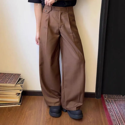 Man wearing brown straight-leg loose drape casual trousers with a relaxed fit.