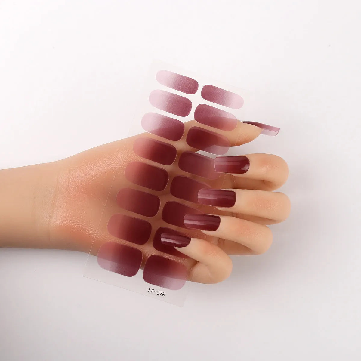 Sheet of 16 small design nail art stickers including cross, rose, tulip and marble patterns.