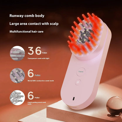 Compact pink and black smart scalp massage comb with red light therapy, shown next to a ruler for scale under 10cm.