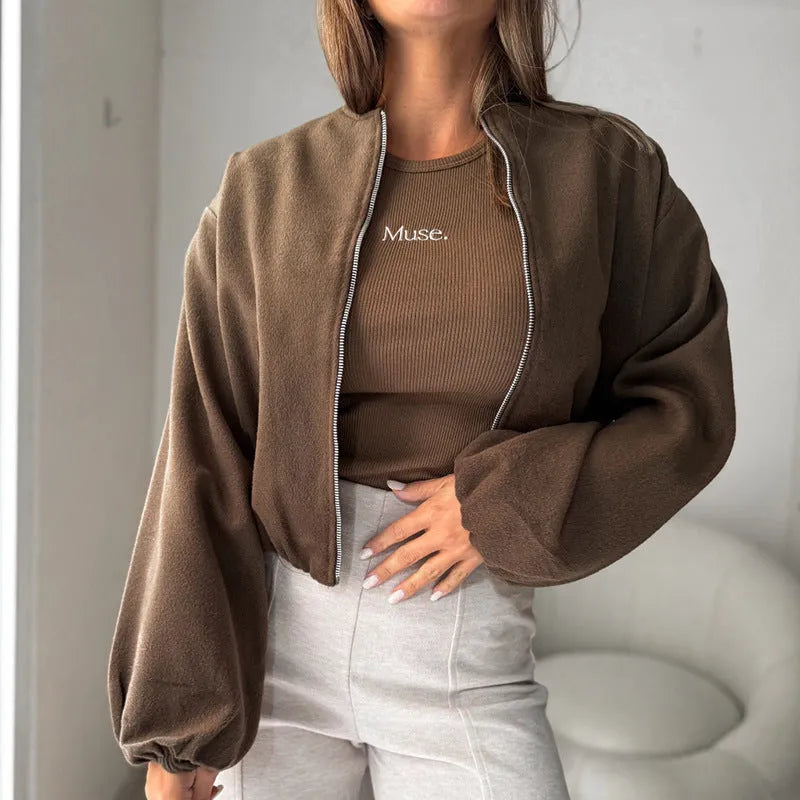 Brown women's off-shoulder short coat with lantern sleeves and pockets on a hanger.