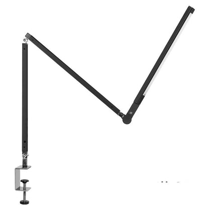Clip-on adjustable arm LED desk lamp in black mounted on a desk edge with remote control.