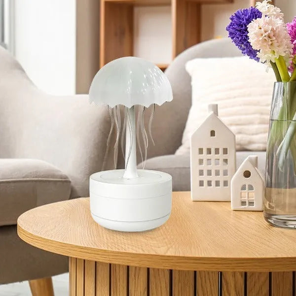 White resin jellyfish humidifier and essential oil diffuser with colourful night light on a desktop.