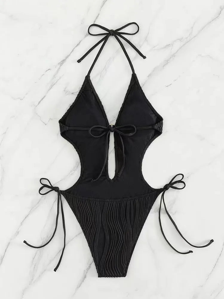Women's black triangle bikini with white lace-up ties on the top