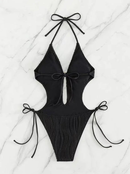 Women's black triangle bikini with white lace-up ties on the top