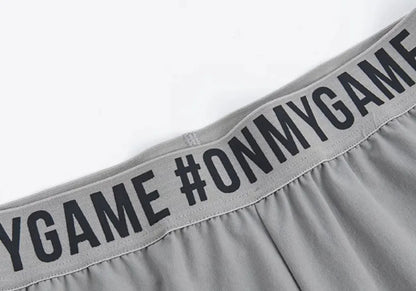 Women's loose sports cropped pants in grey with printed waistband for workouts and running activities