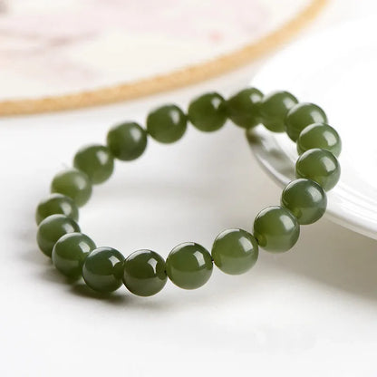 Hetian jade ball bracelet with polished spherical beads in ice-like clear water colours on wrist