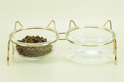 Elegant glass cat bowl with raised metal stand for pets, featuring a shimmering glass bowl and sturdy metal frame to support your cat's hydration and posture.