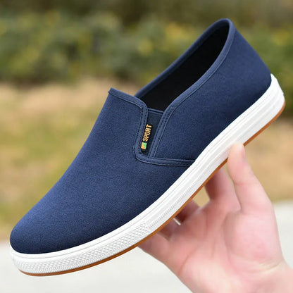 Men's low-top slip-on canvas casual shoes in black with a round toe and composite sole.