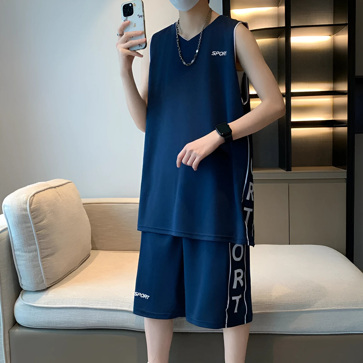 Men's thin polyester basketball sports suit consisting of a sleeveless vest and short pants on a hanger.