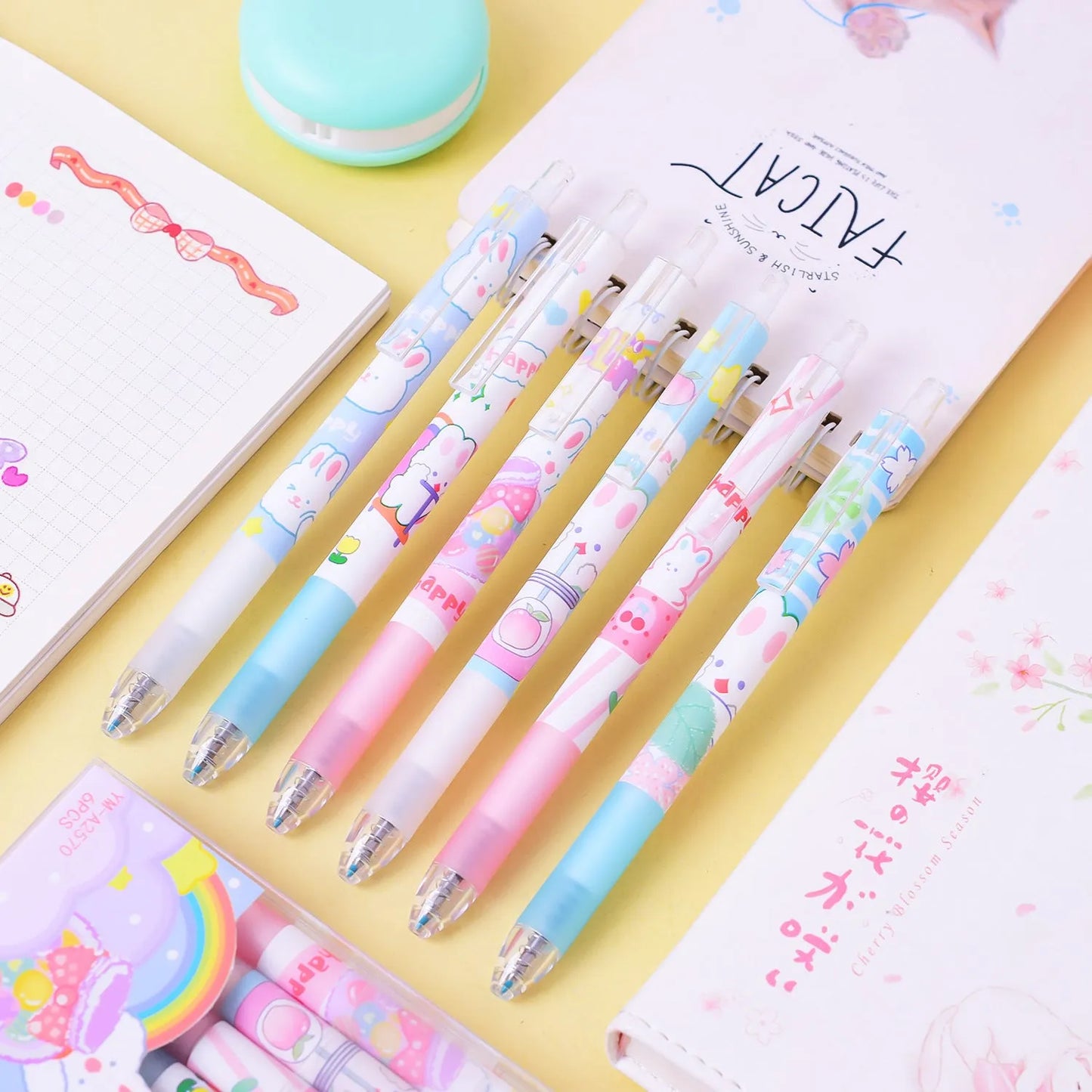 Six black ballpoint pens with cartoon bunny designs showing 0.5mm tips for writing