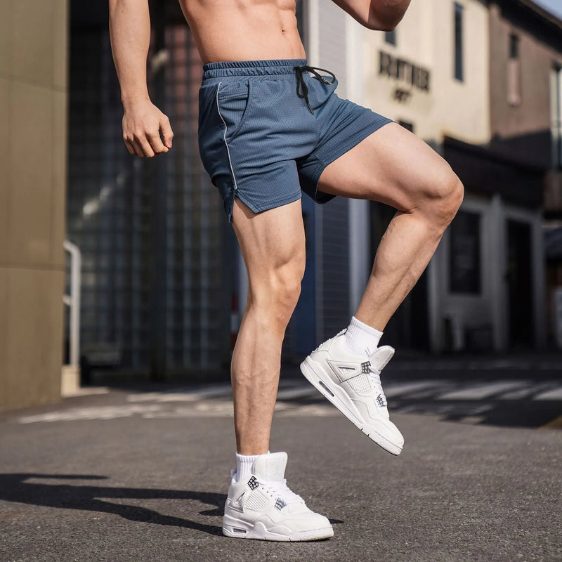 Men's sports casual shorts made from polyester fabric in straight-fit design, available in black, grey, navy blue, and red colours in sizes from M to 3XL, with a practical short length for personalised fitness wear