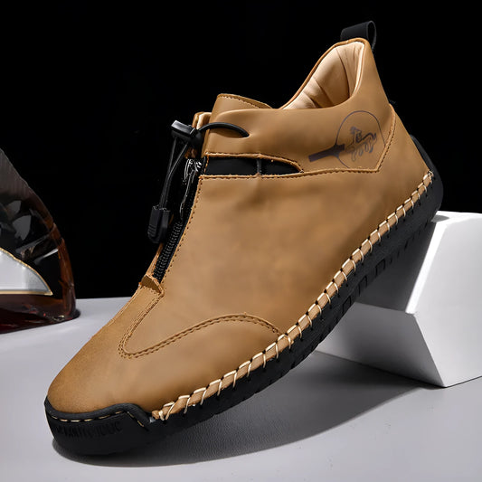 Men's black casual leather shoes with a mid heel, round toe, and visible stitching on a wooden floor.