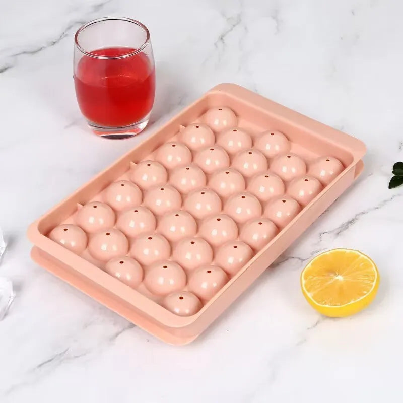 Blue silicone ice cube tray with lid showing 33 round cavities, measuring 24x14cm