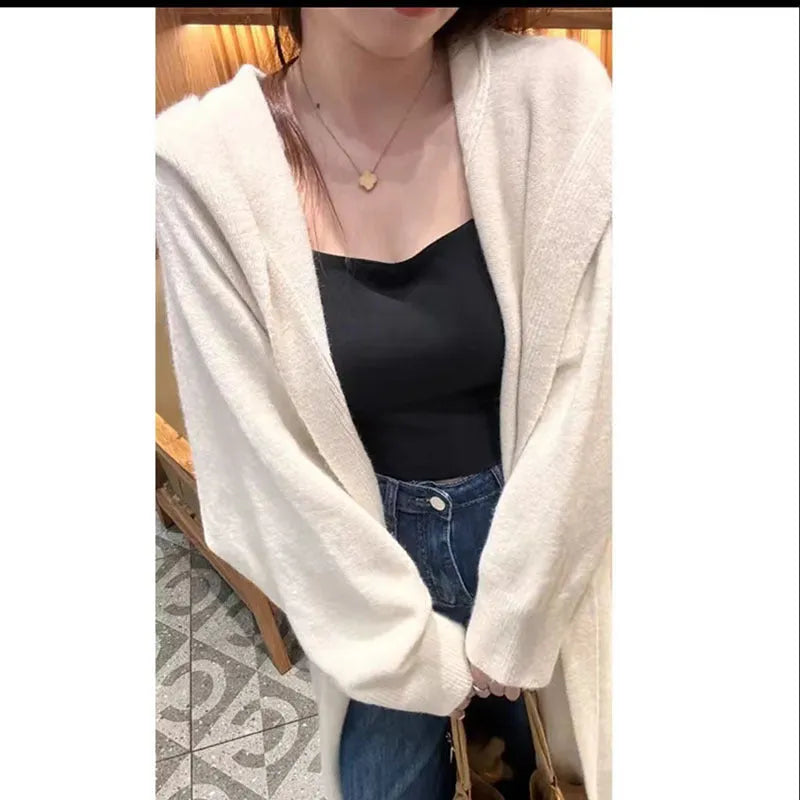 Women's Korean style hooded long knitted cardigan in oatmeal colour, showing loose fit and below-the-knee length