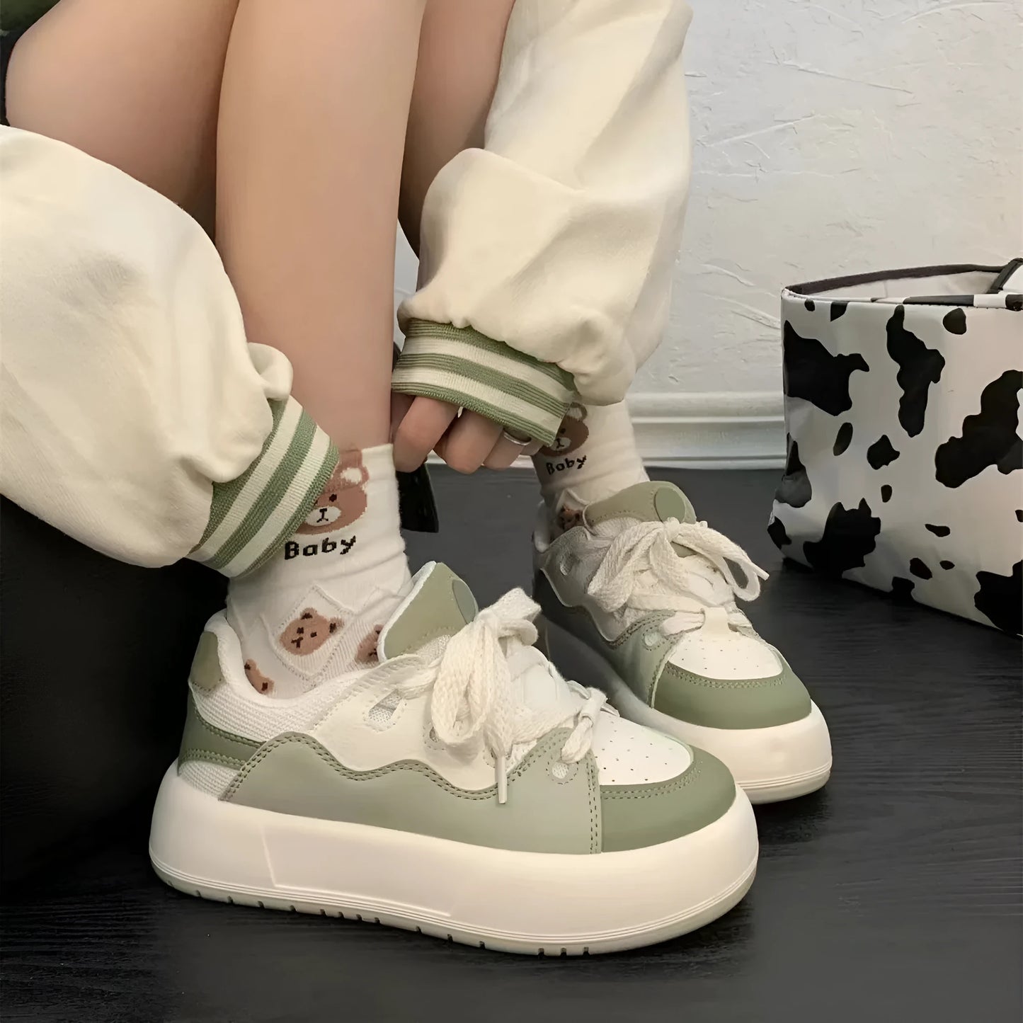 Green women's casual flat shoes with round toe and PU mesh upper on a white background.