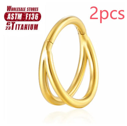 Pair of titanium alloy nose rings on a plain background showing silver, gold, black, and rose gold colour options.