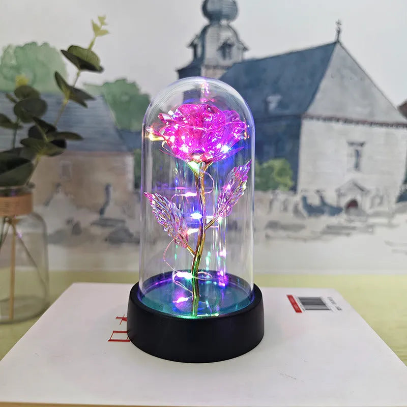 Glass cover small night lamp with plastic flowers, 15cm height, black base, showing colour light options