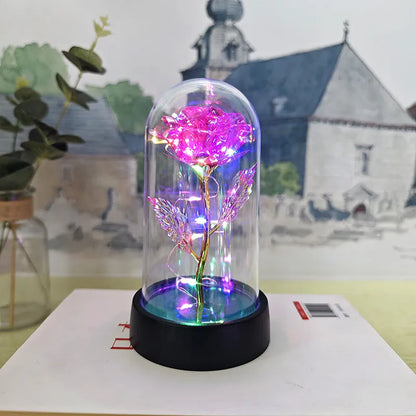 Glass cover small night lamp with plastic flowers, 15cm height, black base, showing colour light options