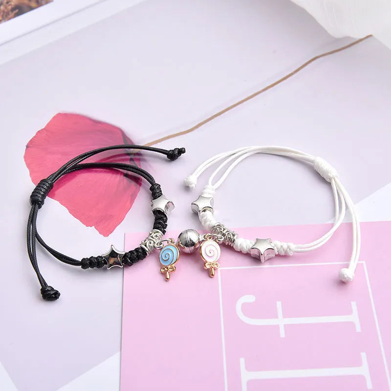 Magnetic suction couple bracelet pair in alloy with an electroplated finish, showing example designs like a crown and love lock.