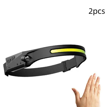 Black silicone USB rechargeable headlamp with a wide COB LED lens and a side wave sensor.