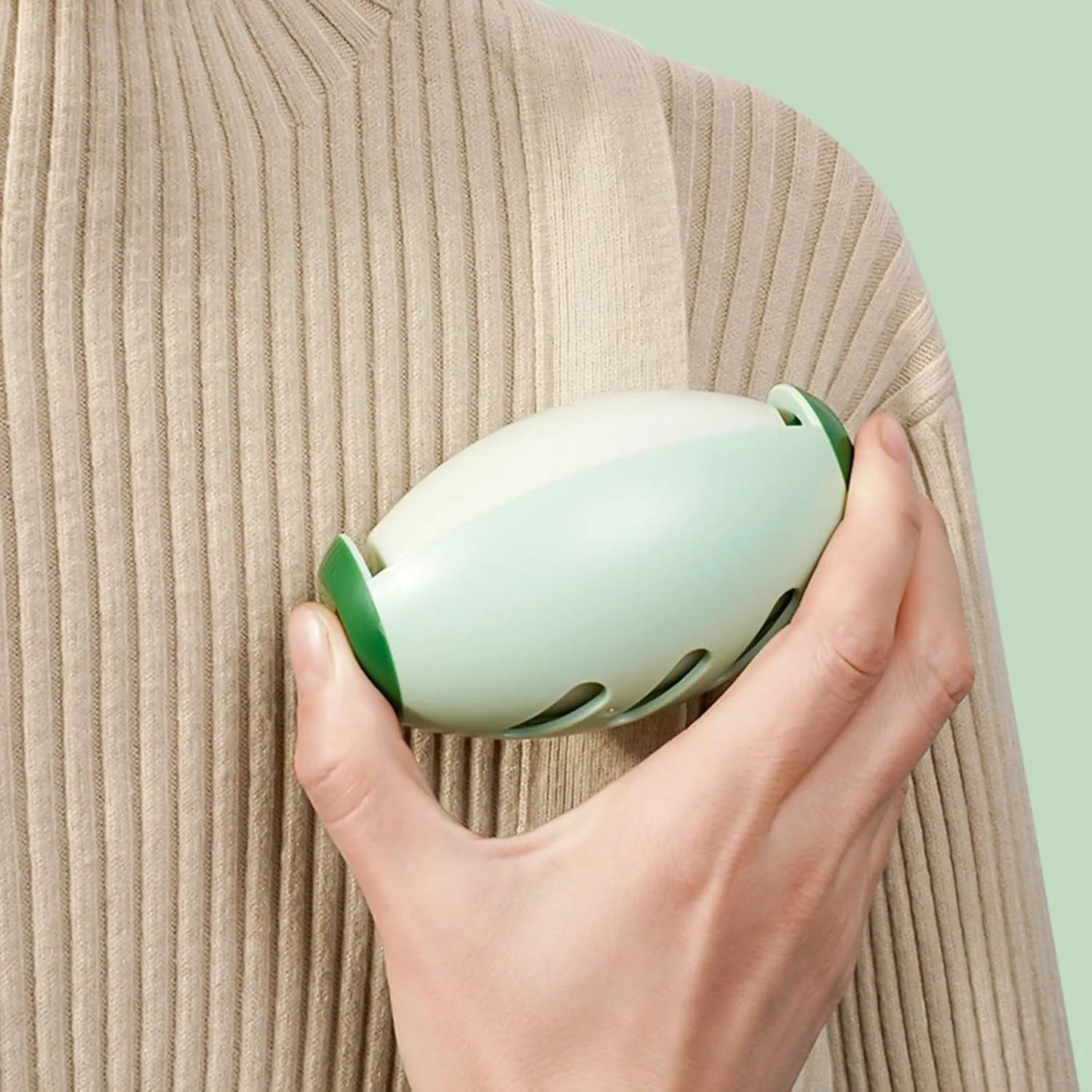 Green and white washable reusable gel lint roller ball for pet hair removal on clothes and furniture