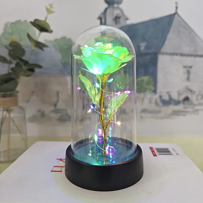 Glass cover small night lamp with plastic flowers, 15cm height, black base, showing colour light options