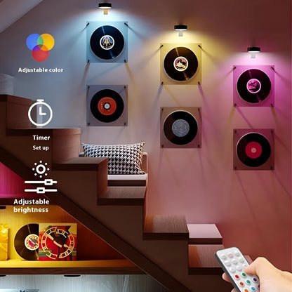 Black magnetic LED painting lamp with remote control on a white wall.
