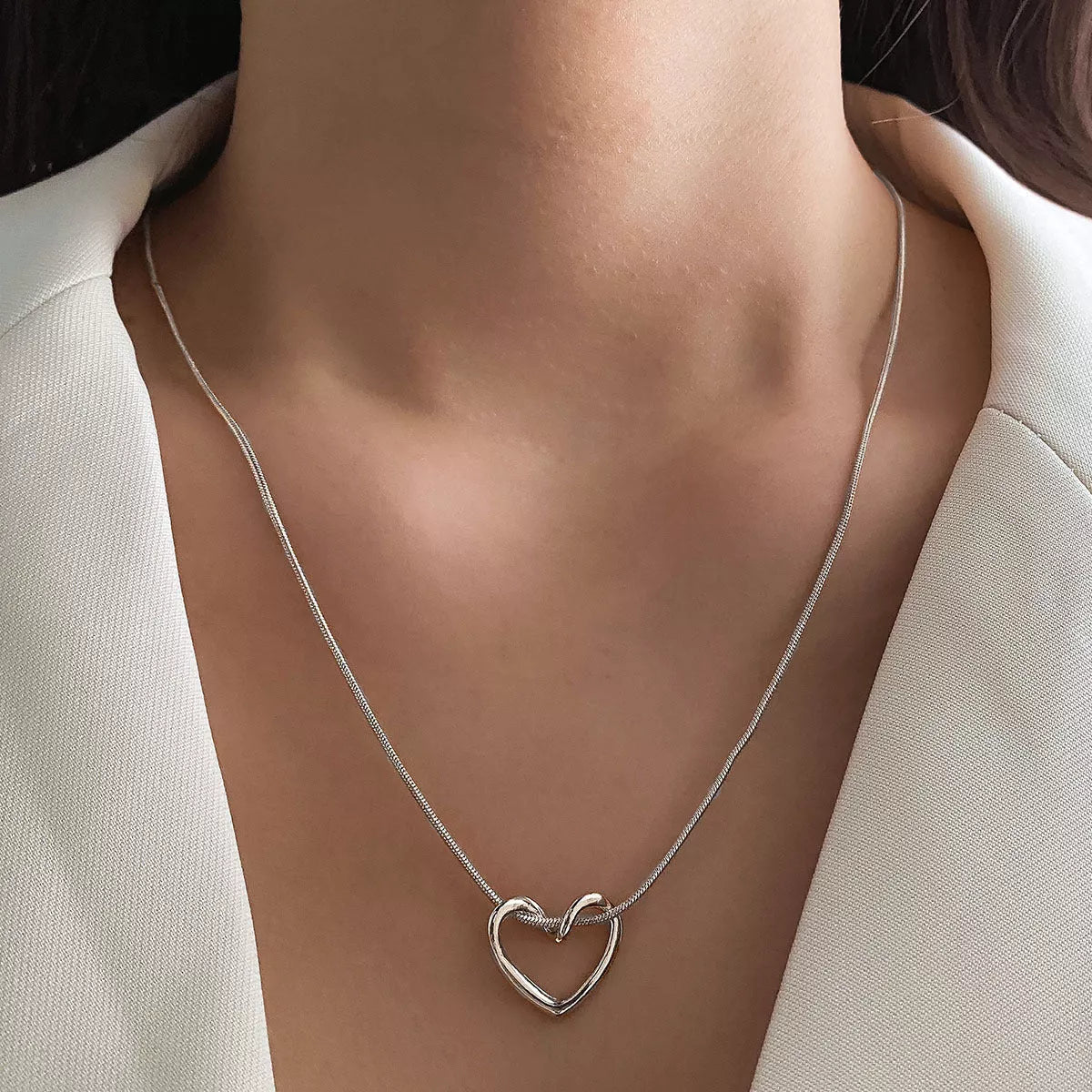 Niche Hollow Heart Necklace for women with snake bones chain and electroplated alloy