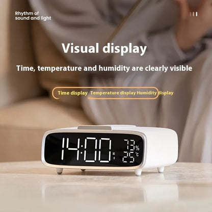 White Bluetooth speaker wireless charger with night lamp functions on wooden surface