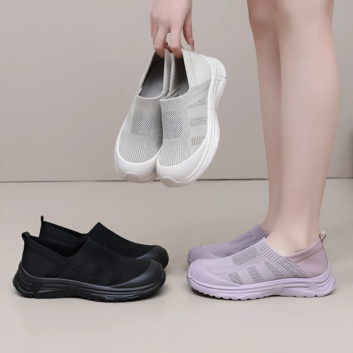 Women's one pedal slip-on shoe in black with cloth upper and PVC sole, showing round toe and flat heel design.
