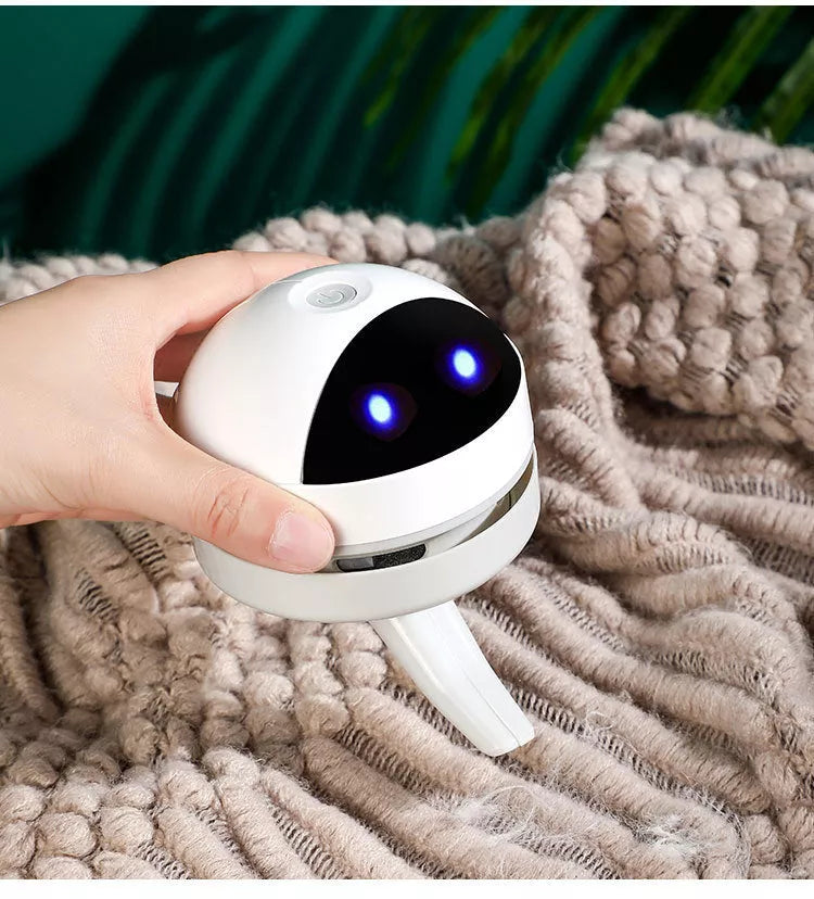 Compact USB charging wireless mini portable robot desktop vacuum cleaner on a desk