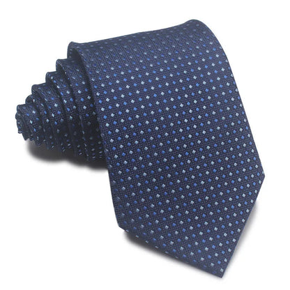 Close-up of a red and black striped jacquard weave tie with an arrow tip, showing texture.