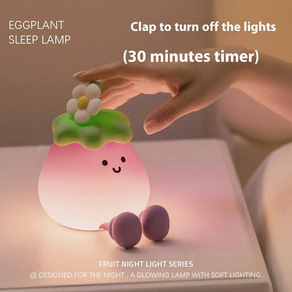 Cartoon eggplant shaped night lamp emitting soft yellow light, showing compact dimensions