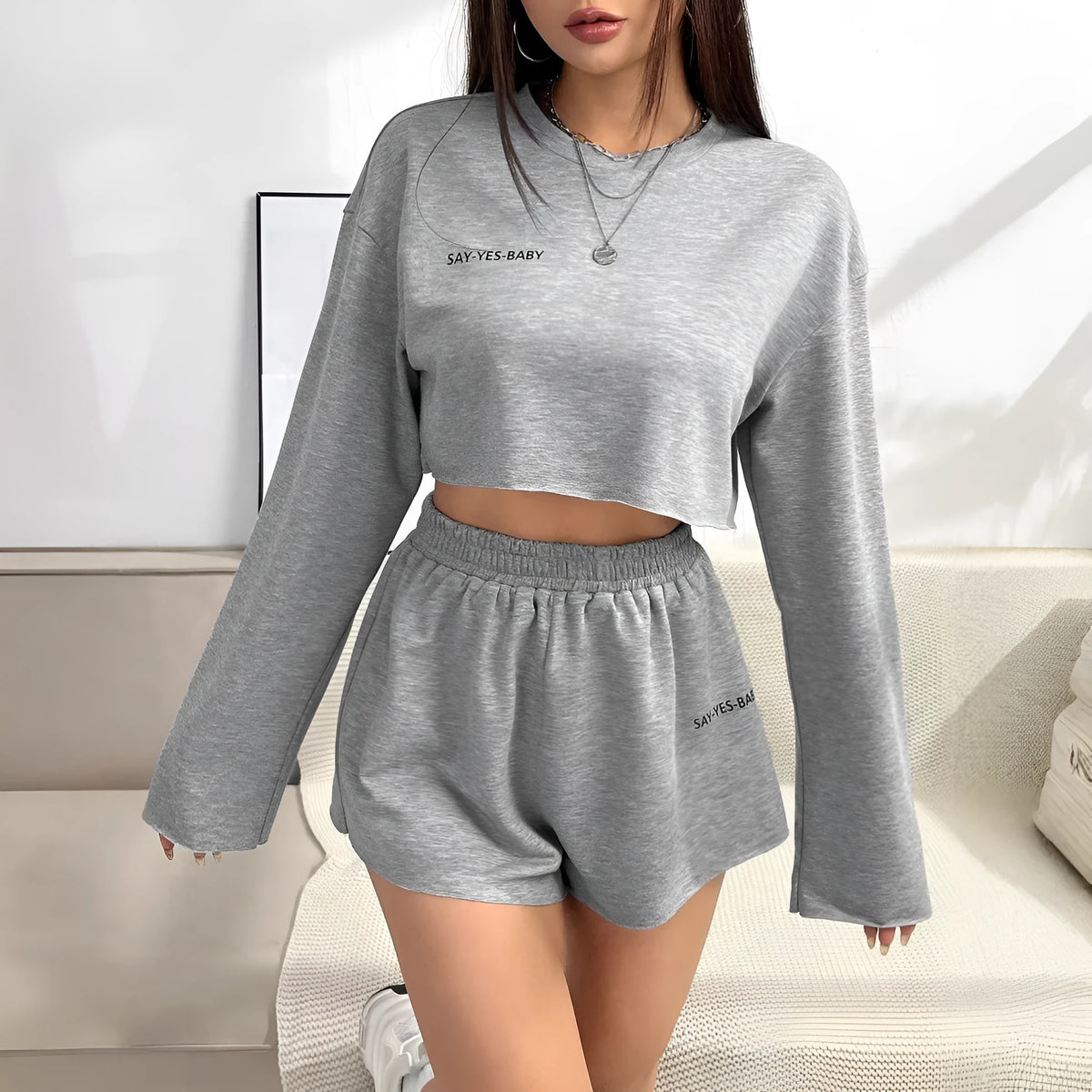 Grey women's long-sleeved T-shirt and shorts polyester set laid flat
