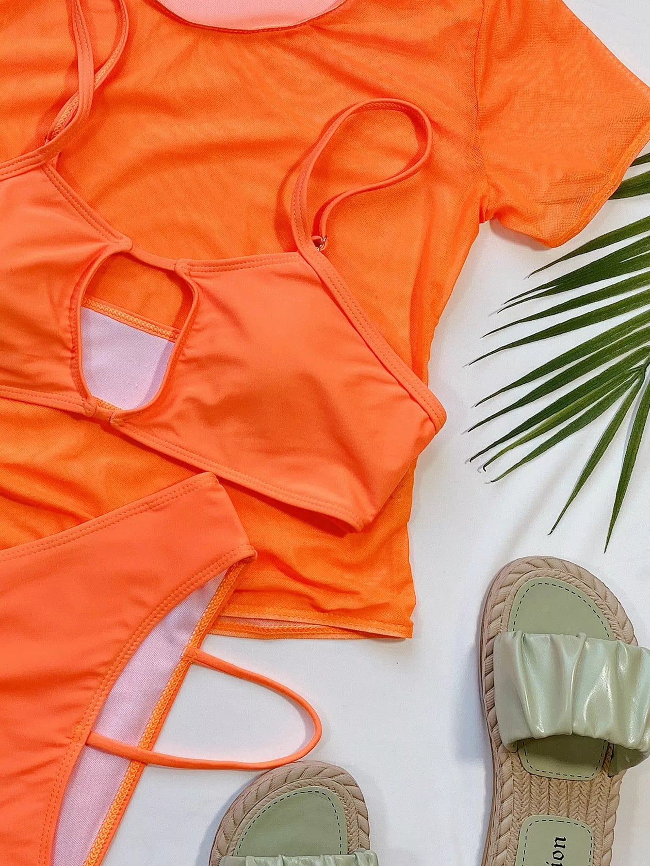 Orange high-waist ladies bikini three-piece set on a beach backdrop